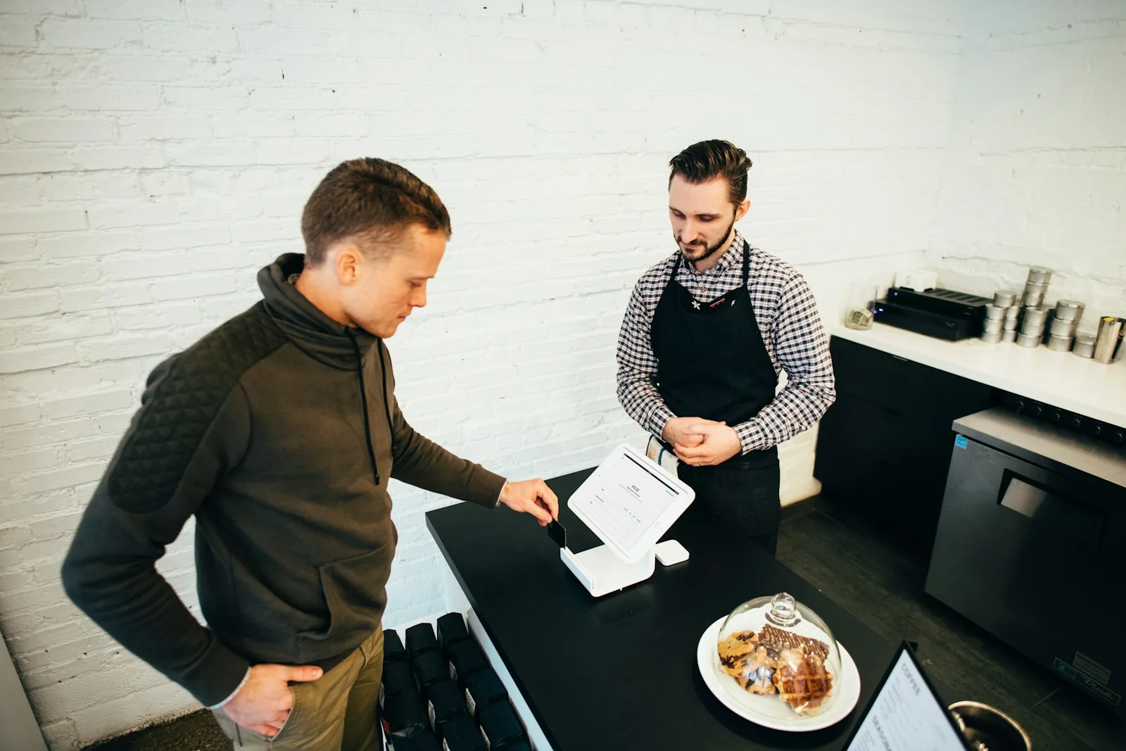 A customer and small-business owner completing a transaction