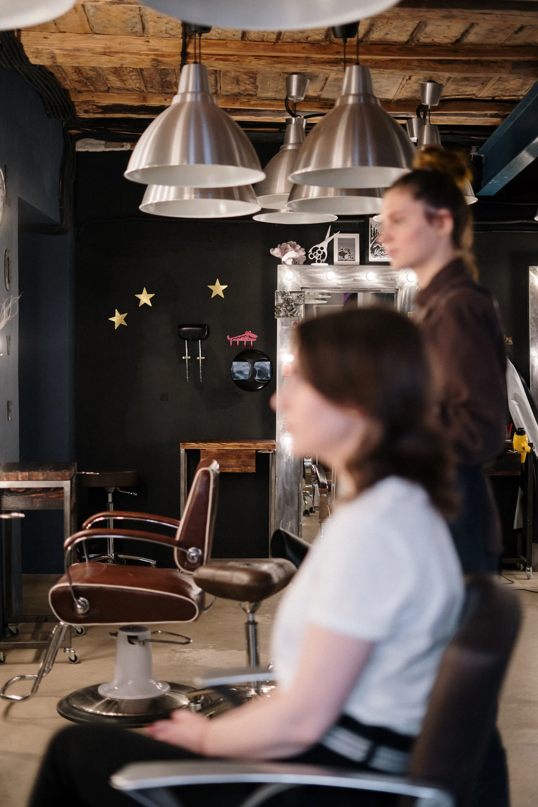 A stylist consulting with a seated client in a hair salon