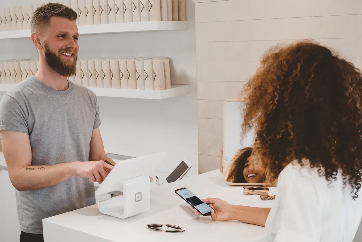 A customer speaking with a small-business owner at the point of sale